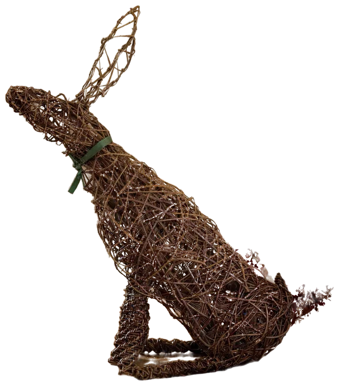 The finished moon gazing hare, woven in brown willow with a green ribbon at its neck