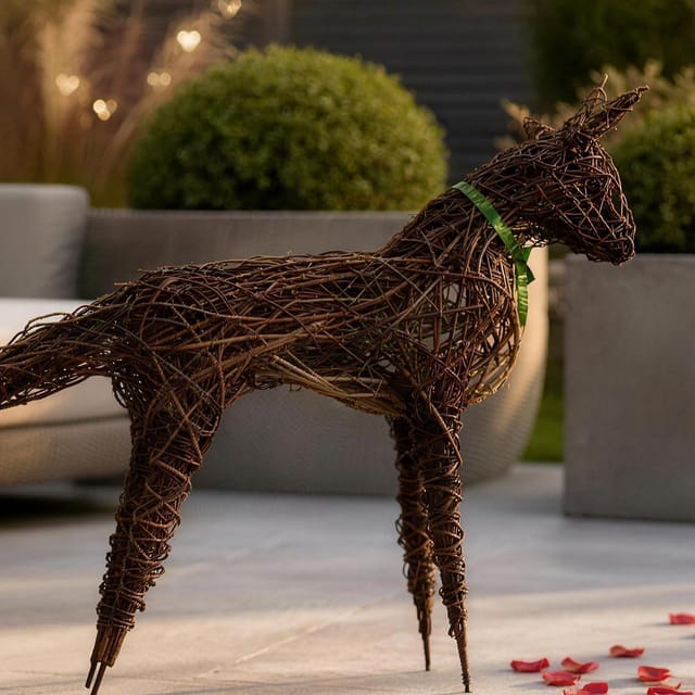 The willow fox with a green ribbon at its neck